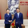 Minister of Justice Le Thanh Long (R) receives his visiting Chinese counterpart He Rong in Hanoi on April 19. (Photo: VNA)