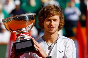 Russia’s Andrey Rublev celebrates with the trophy after winning the Monte Carlo final against Denmark’s Holger Rune on April 16. (Photo: Reuters)