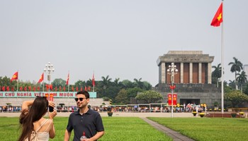 Foreign tourists take photo in front of the Mausoleum of President Ho Chi Minh in Hanoi