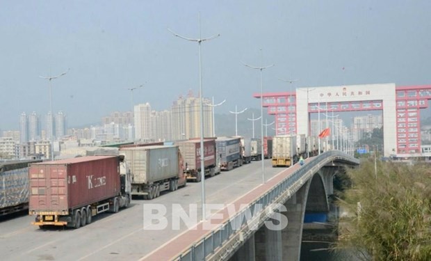 Trucks carry goods to China via Mong Cai International Border Gate. (Photo: VNA) 