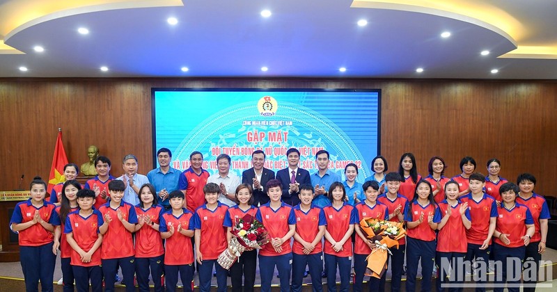 The delegates, Vietnamese women’s football team and athlete Nguyen Thi Oanh pose for a photo.