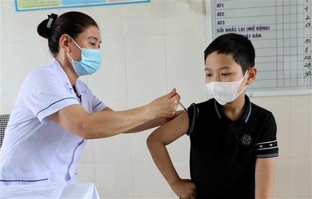A boy gets vaccinated against COVID-19. (Photo: VNA)