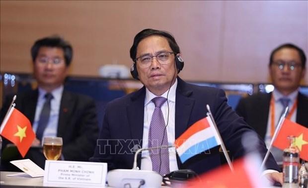 Prime Minister Pham Minh Chinh at the meeting with leaders of several large economic groups of Luxembourg and Europe (Photo: VNA)