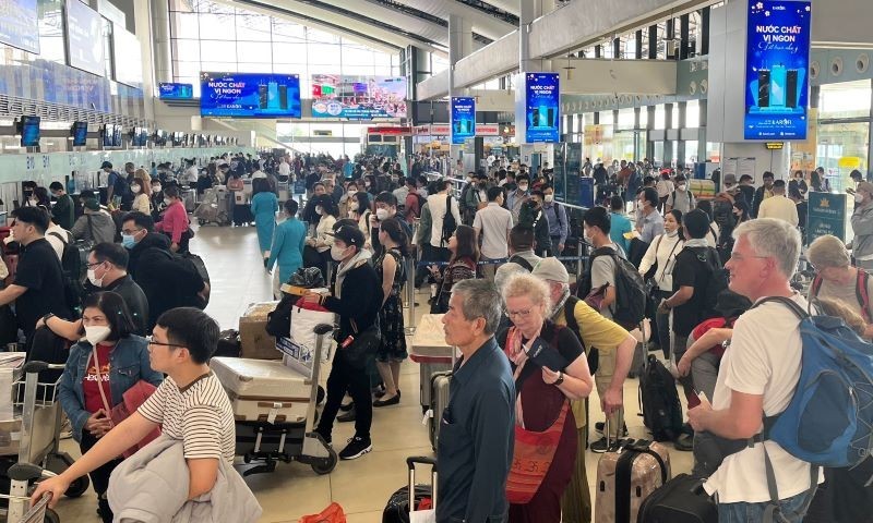 Passengers checking in at Noi Bai airport.