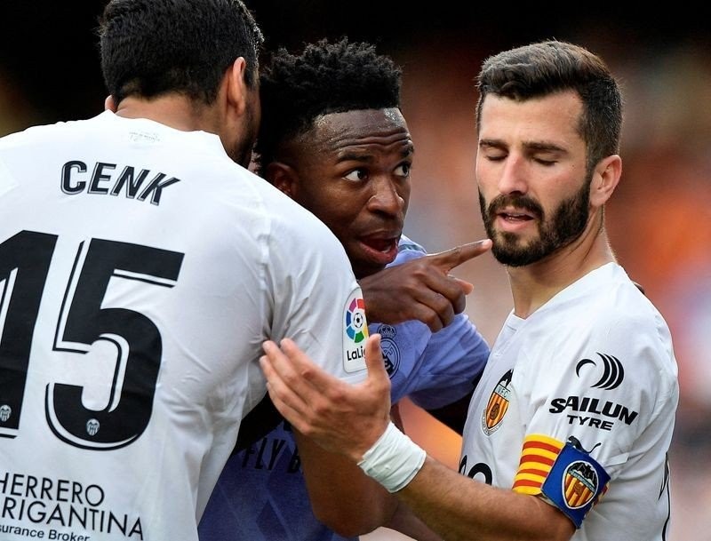 Real Madrid's Vinicius Junior gestures towards a fan after witnessing abuse as Valencia's Jose Gaya and Cenk Ozkacar attempt to restrain him - LaLiga - Valencia v Real Madrid - Mestalla, Valencia, Spain - May 21, 2023. (Photo: Reuters)