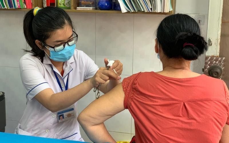 A woman gets vaccinated against COVID-19.
