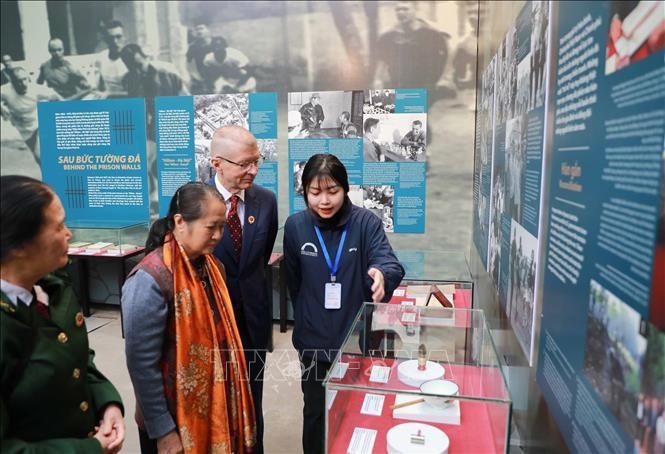 Visitors to the exhibition that opened at the Hoa Lo Prison relic site on December 9. (Photo: VNA)