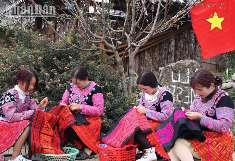 H'mong women making costumes for their family members to dress during Tet.