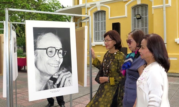 Visitors look at a photo of late composer Trinh Cong Son. (Photo: VNA)