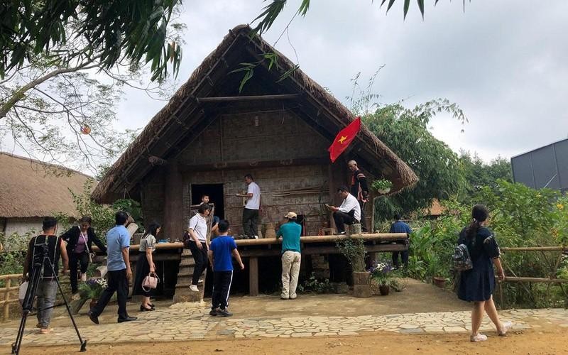 Visitors at an Ede house in the Vietnam ethnic culture and tourism village on the outskirts of Hanoi.
