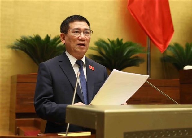 Minister of Finance Ho Duc Phoc delivers the Government's report on thrift practice and wastefulness prevention in 2022 at the 15th NA's fifth session on May 23. (Photo: VNA)