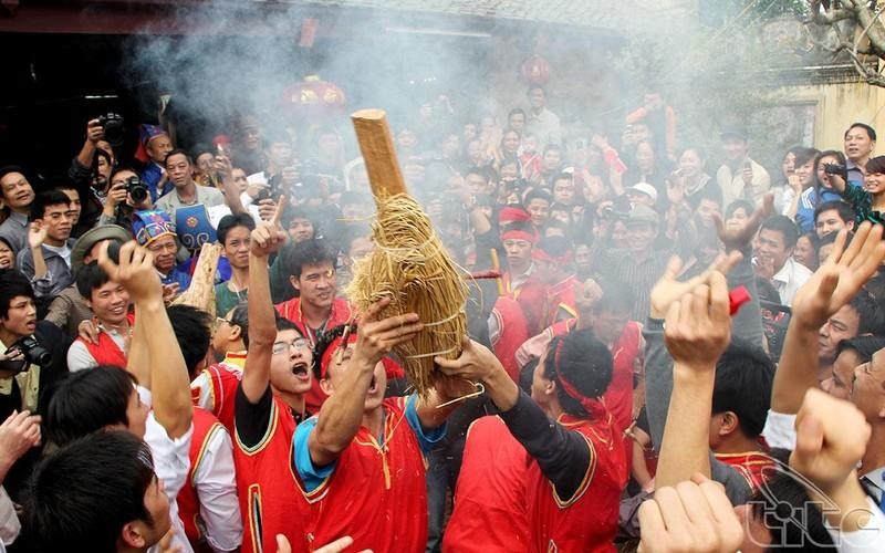 People cheer when a team make fire successfully, in preparation for cooking rice. 