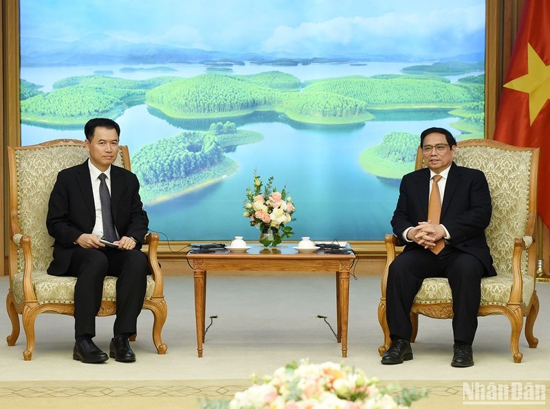 PM Pham Minh Chinh (R) and Lao Minister of Industry and Commerce Malaythong Kommasith at the meeting in Hanoi on December 23. (Photo: NDO)