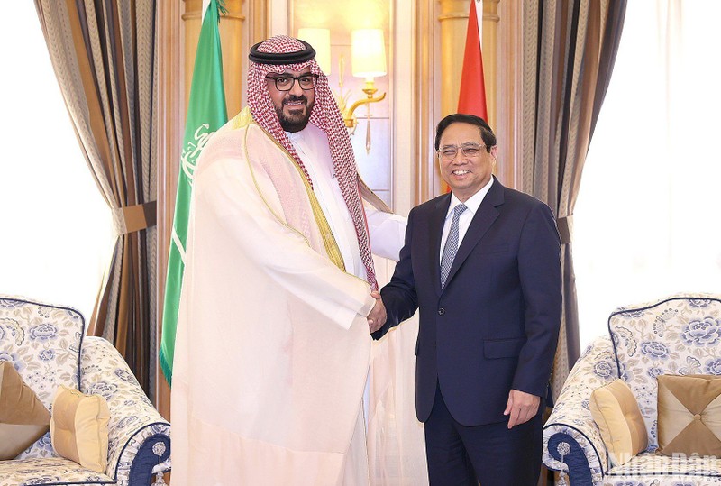 Prime Minister Pham Minh Chinh (R) and Saudi Arabia's Minister of Economy and Planning Faisal Al-Ibrahim.