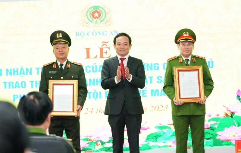 Deputy PM Tran Luu Quang presents the Prime Minister's Letter of Commendation to groups with outstanding achievements in preventing and fighting drug-related crimes. (Photo: NDO)