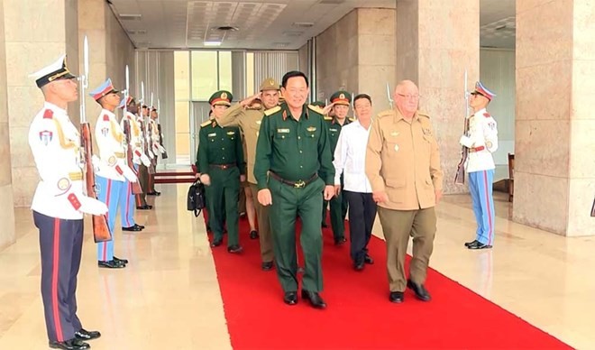 Senior Lieutenant General Álvaro López Miera, Minister of the Cuban Revolutionary Armed Forces welcomes the delegation of Vietnam's National Defence Ministry. (Photo: qdnd.vn)