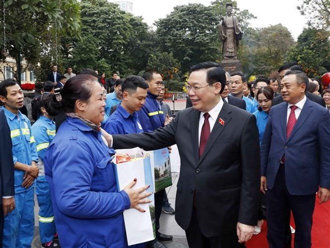 National Assembly Chairman Vuong Dinh Hue presents gifts to workers in the capital city as part of his visit on February 7 visit to extend Tet greetings to the Party Organisation, administration and people of Hanoi. (Photo: VNA)