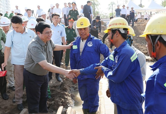 PM Pham Minh Chinh (left) meets workers of the Ring Road 3 project in Ho Chi Minh City on February 13. (Photo: VNA)