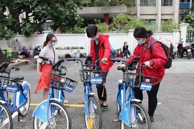 Young people use the public bicycle-sharing service in HCM City. The service has received positive feedback from locals so far. (Photo: VNA)