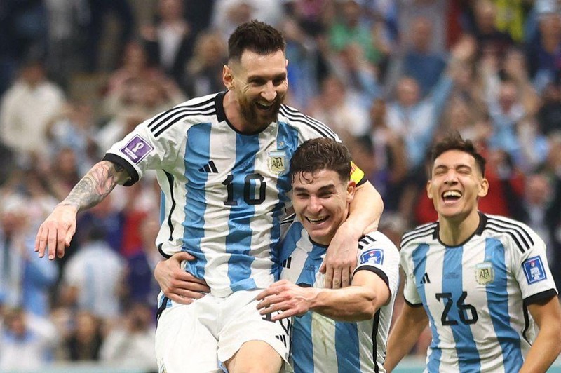 Argentina's Julian Alvarez celebrates scoring their second goal with Lionel Messi and Nahuel Molina