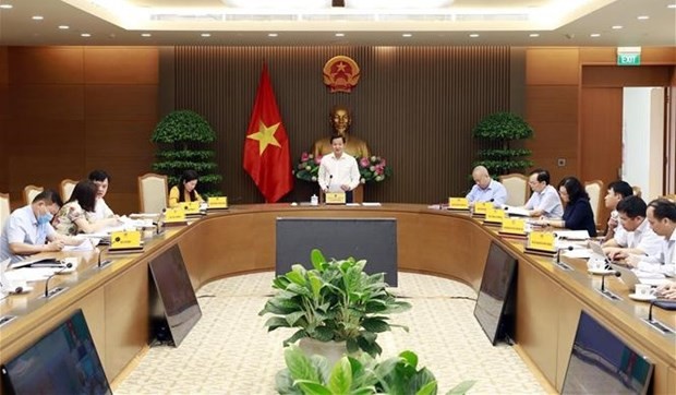 Deputy PM Le Minh Khai (standing) speaks at the teleconference on April 24. (Photo: VNA)