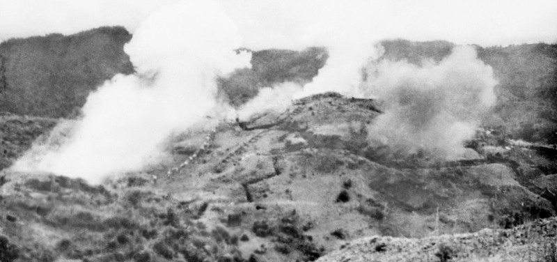 The enemy's defensive positions on Him Lam hill that were hit by Vietnamese soldiers' artillery fire are on fire. These positions were destroyed on March 13, the opening day of the campaign. (Photo: VNA)