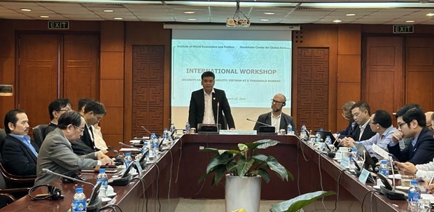 Acting Director of the IWEP Dr. Phi Vinh Tuong (standing) addresses the workshop in Hanoi on March 22. (Photo: VNA)
