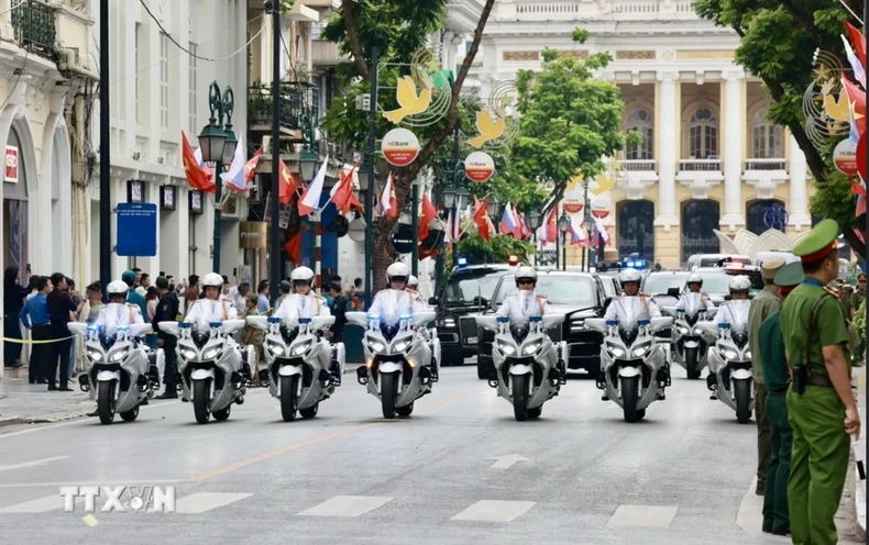 The escort convoy brings Russian President Vladimir Putin to the Presidential Palace. (Photo: VNA)