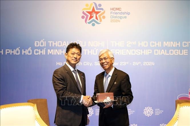 Japanese Vice Minister for Foreign Affairs Komura Masahiro presents a souvenir to Vice Chairman of the Ho Chi Minh City People's Committee Vo Van Hoan (Photo: VNA)