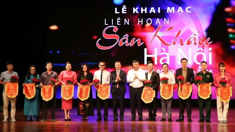 Photo: Organising board presents flowers to the units participating in the festival.