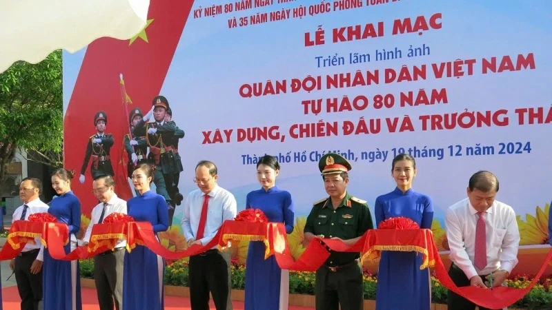 Delegates cutting ribbon to open exhibition