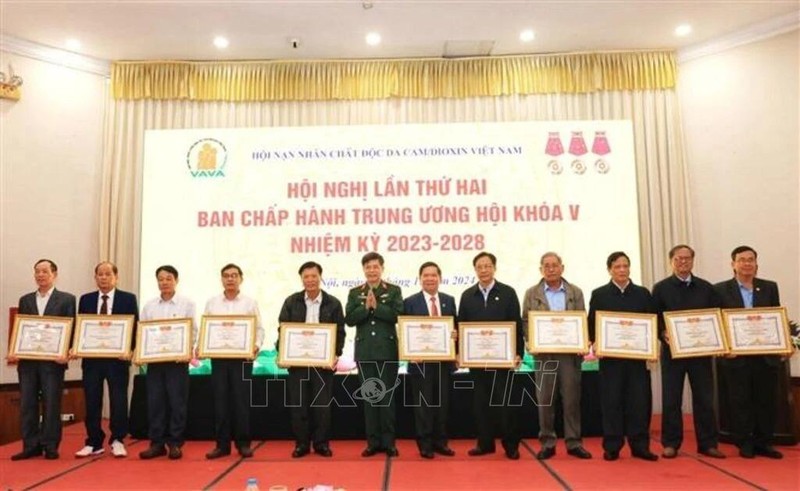 Individuals are honoured at the event for their contributions to activities for AO victims in 2024. (Photo: VNA)