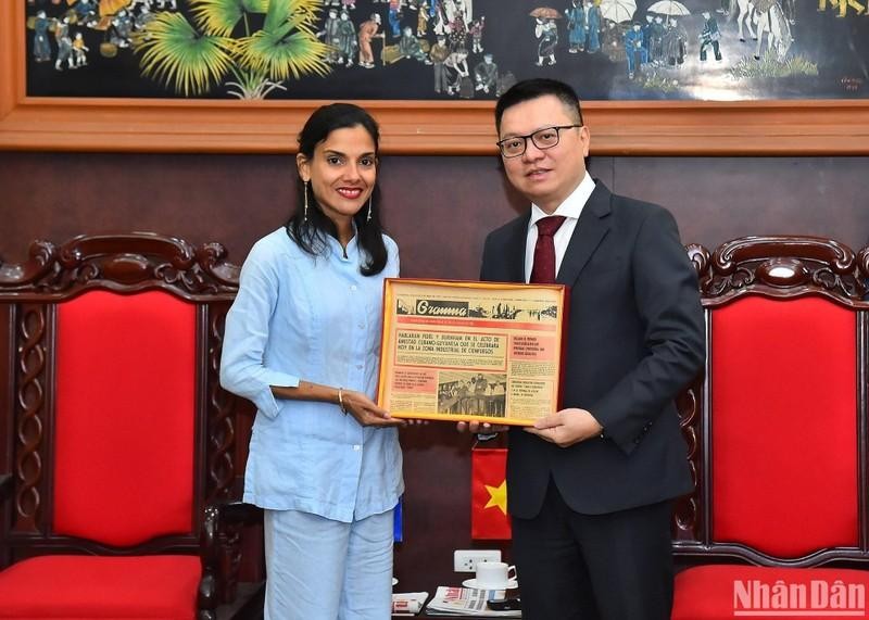 Nhan Dan (People) Newspaper Editor-in-chief Le Quoc Minh receives a gift from Deputy Director of Granma Newpaper Arlin Alberty Loforte. (Photo: NDO/Thuy Nguyen)