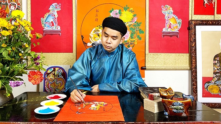 Young painter Nam Chi working on a cat folk painting.