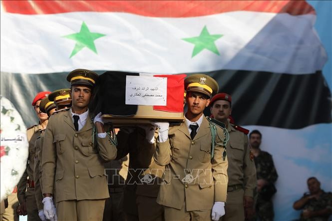 Funeral held for soldiers who died in a drone attack in Homs. (Photo: AFP/VNA)