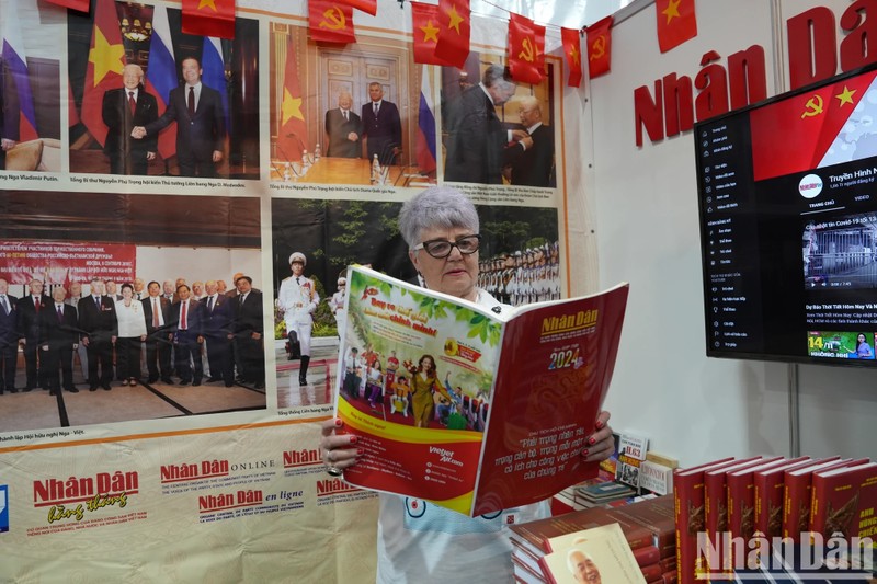 A visitor at the stall of Nhan Dan (People) in Saint Petersburg International Book Fair 