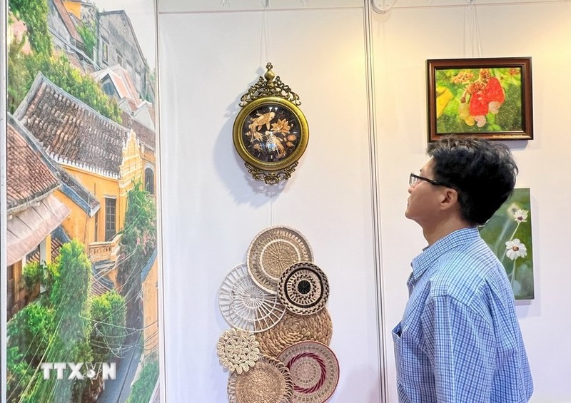 A visitor watches Vietnamese products on display at the Hong Kong art expo . (Photo: VNA)