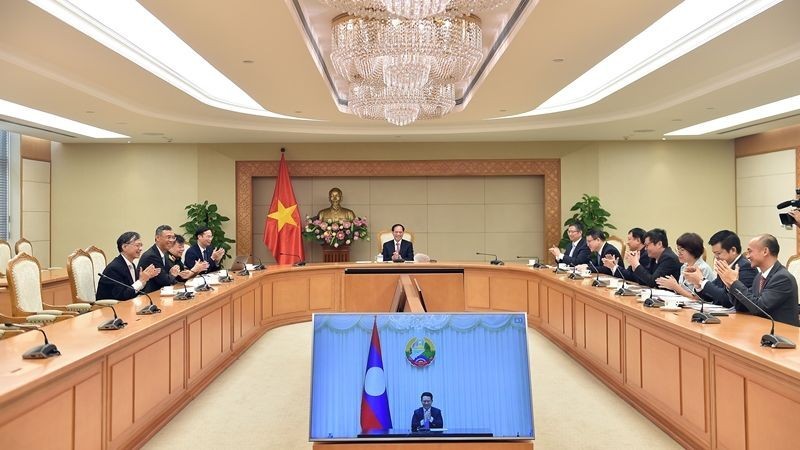 Deputy PM, FM holds online talks with Lao counterpart (Photo: VGP)