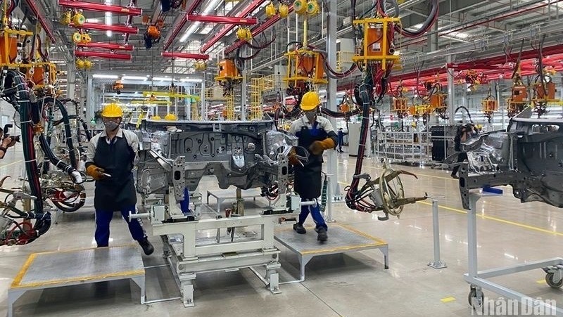 Workers assembling car parts at a plant of Hyundai Thanh Cong Automobile JSC