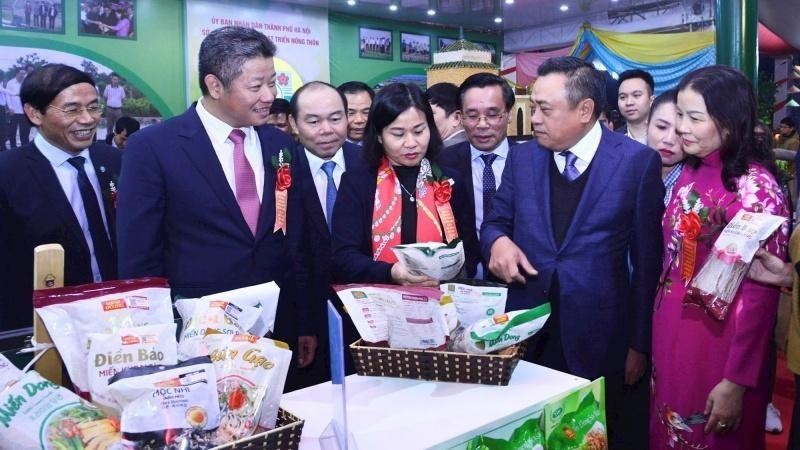 Delegates visit booths displaying agricultural products.