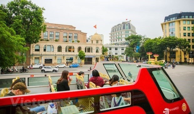 Visitors on a double-decker bus tour around Hanoi (Photo: Vietnam Plus)