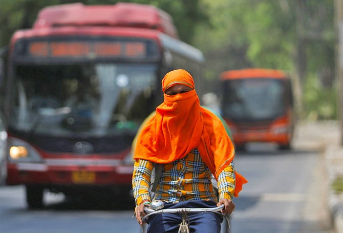 A man rides a cycle with his face fully covered, on a hot summer day, in New Delhi, India, April 26, 2022. (Photo: REUTERS/Anushree Fadnavis)