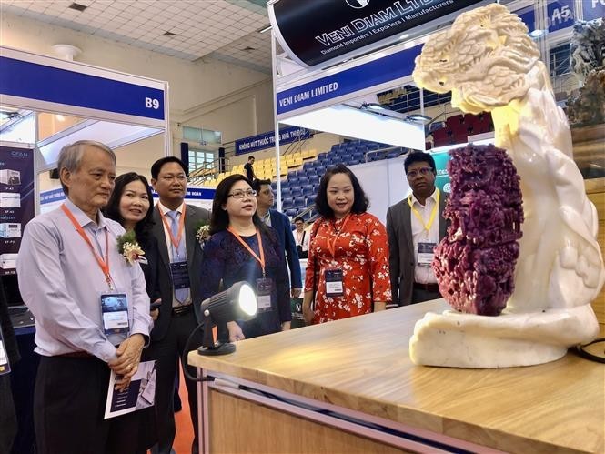 People visit a booth at the exhibition. (Photo: VNA)