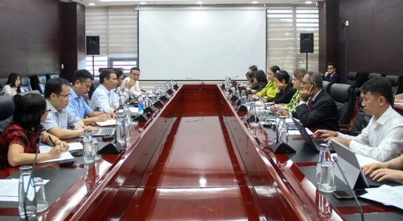 Delegates attend the working session.