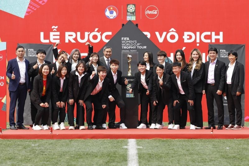 Members of the Vietnam women’s team pose a for a photo with the World Cup trophy.