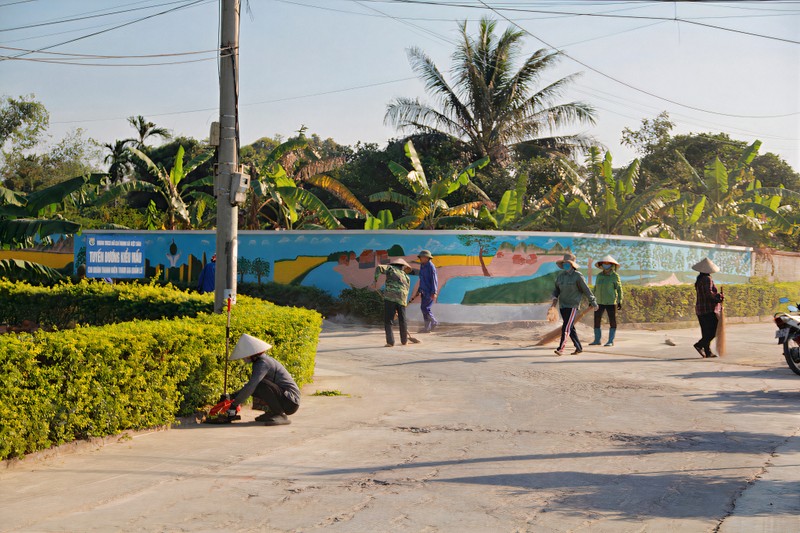 Residents in Dong Trieu Town clean up roads in their neighbourhood.