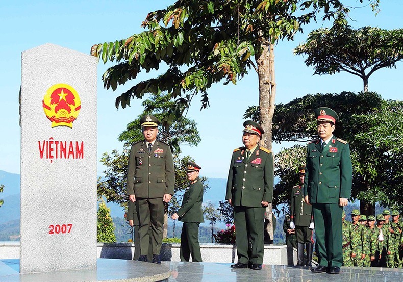 Front, from right: Minister of National Defence of Vietnam General Phan Van Giang, Deputy Prime Minister and Minister of National Defence of Laos General Chansamone Chanyalath, and Deputy Prime Minister and Minister of National Defence of Cambodia General Tea Seiha stand in front of the border marker at the border T-junction of the three countries on December 14.