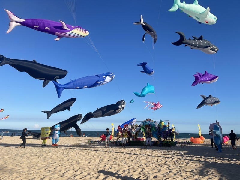Giant kites shaped like sea creatures are flown at the festival.