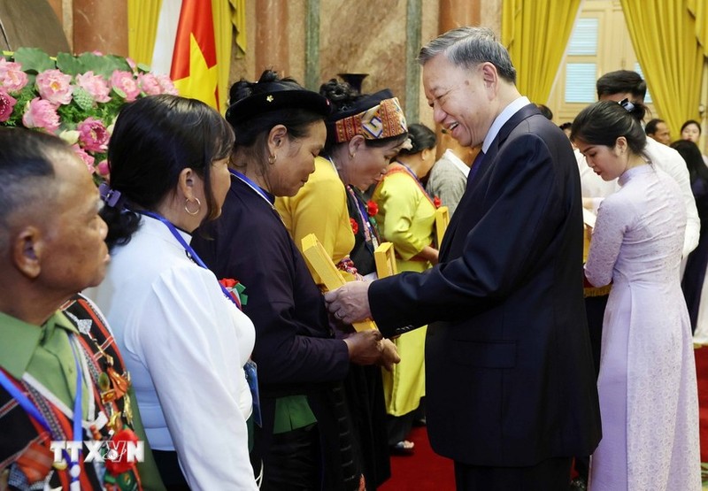 President To Lam presents gifts to outstanding ethnic representatives. (Photo: VNA)