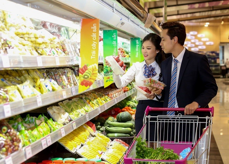 Consumers shop for food at a supermarket in Hanoi.